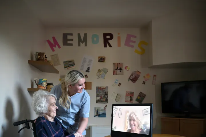 old lay with caregiver and a komp pro device