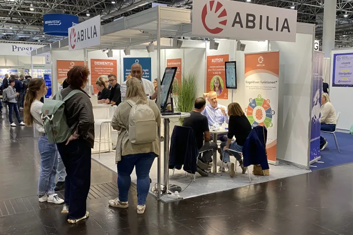 Stand at exhibition where visitors is demonstrated a product