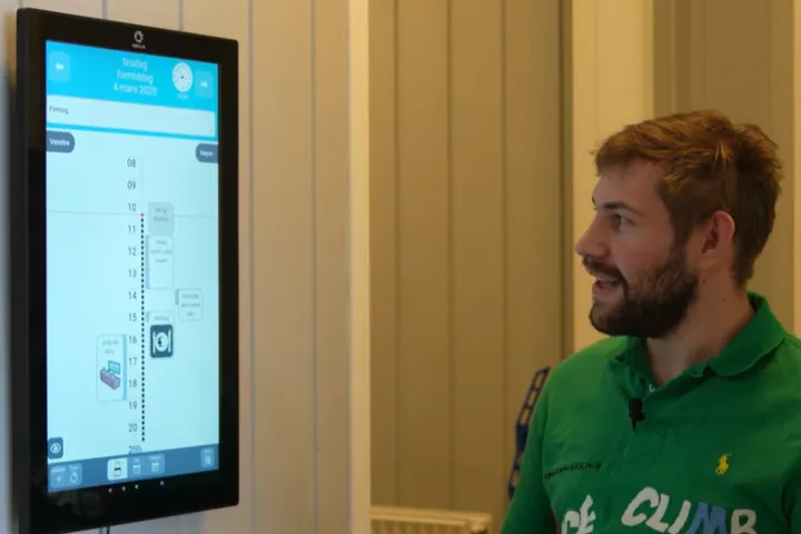 Man smiling looking at digital device