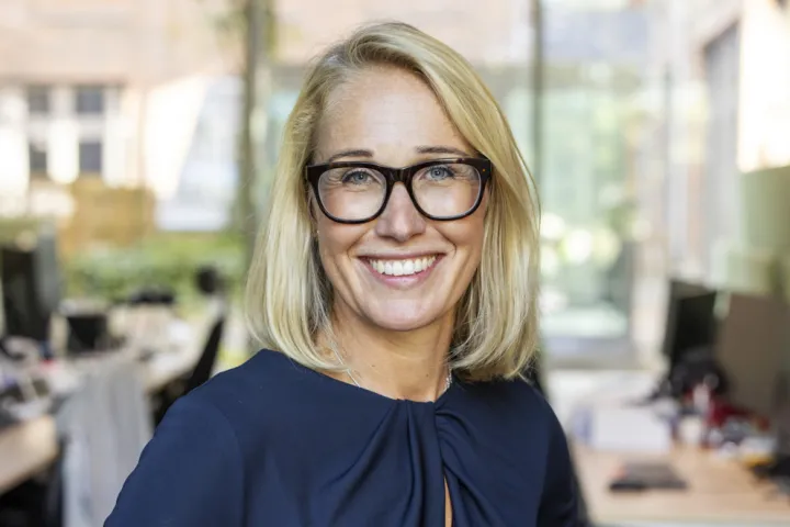 Portrait of a business woman smiling, blonde with glasses